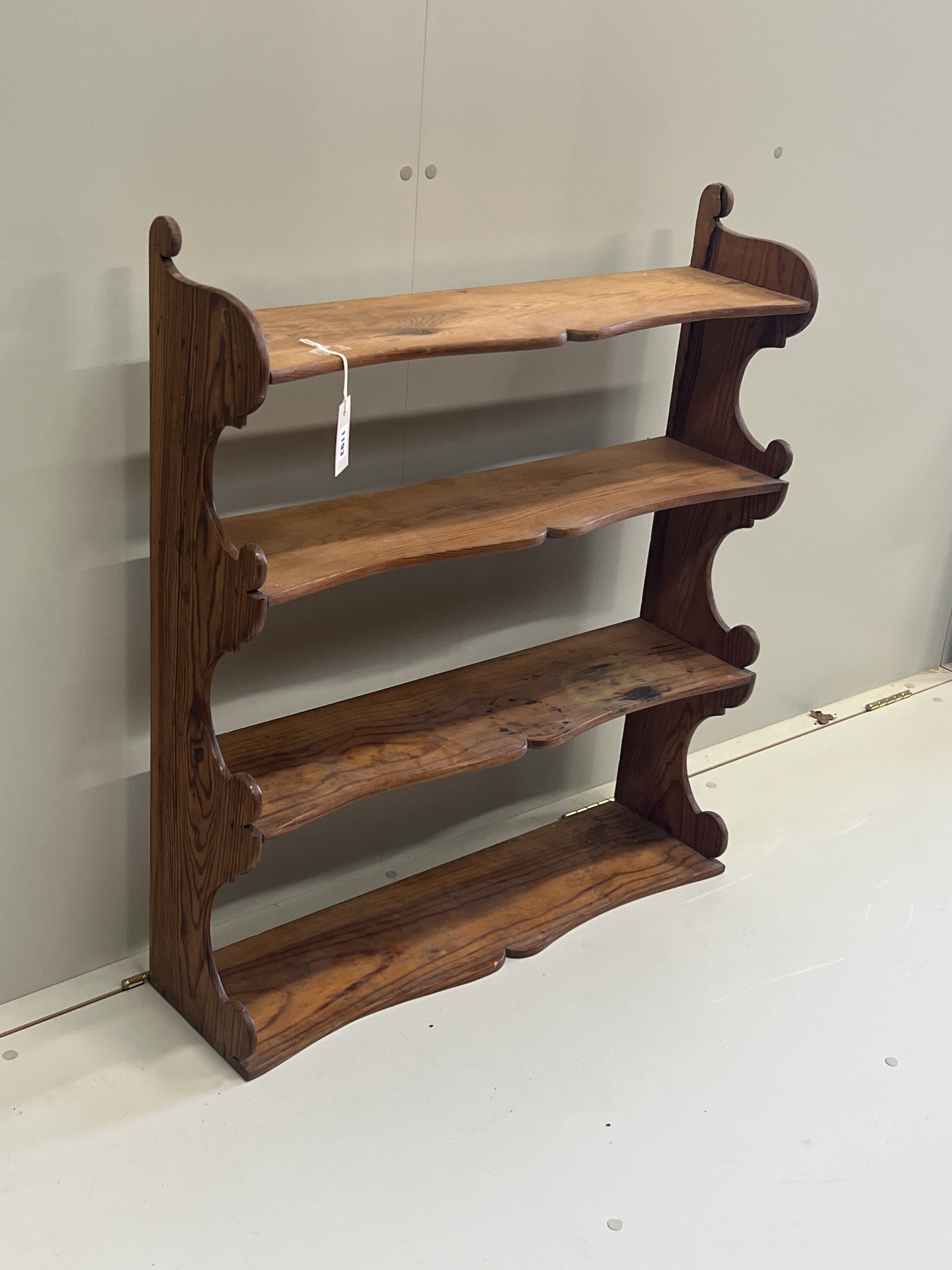 A Victorian pitch pine four tier wall bracket, width 75cm, depth 21cm, height 87cm